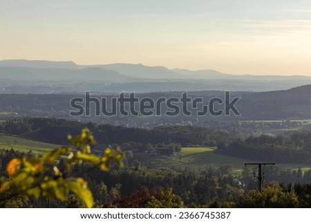 german landscape in rural countryside with mountains on the horizon at sundown evening in september