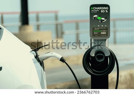 Electric car recharging battery at outdoor EV charging station for road trip or car traveling by the seascape, alternative and sustainable energy technology for eco-friendly car. Perpetual