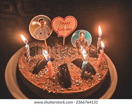 Chocolate ice cream cake decorated with Oreos. and colorful granulated sugar Along with embroidering pictures and blessings, and placing candles and lighting candles for light.