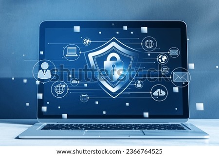 Close up of laptop with creative glowing padlock hologram on blurry background with various icons. Safety and security concept