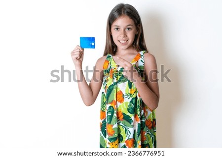 Photo portrait of young beautiful kid girl doing purchase with pointing finger credit bank card