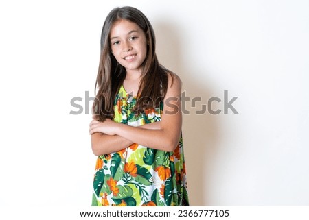 young beautiful kid girl arms crossed look empty space billboard