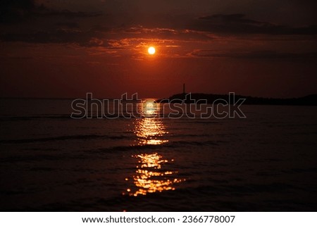 Dark red sunset by the sea. Sunset with pier background. Soft selective focus