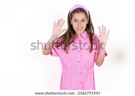 young beautiful kid girl showing and pointing up with fingers number ten while smiling confident and happy.