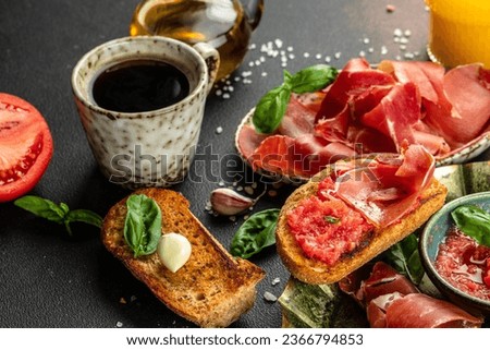 Traditional Spanish breakfast. Tostada with Jamon Iberico ham and tomatoes, olive oil bread with coffee. banner, menu, recipe place for text, top view. Royalty-Free Stock Photo #2366794853