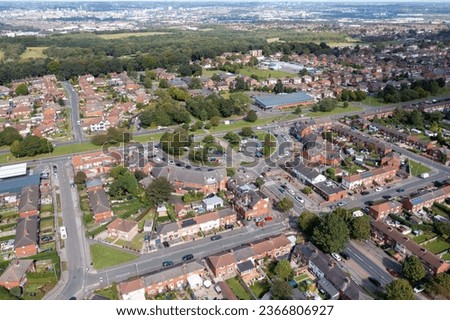 Aerial drone photo of the town of Middleton, Leeds in the UK showing the British housing estates and streets on a sunny day in the summer time.
