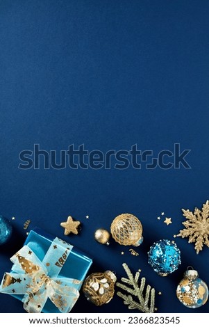 Christmas vertical banner design, poster mockup, Xmas party invitation template. Luxury gold Christmas balls, stars, decorations,  glistering gift boxes on dark blue background. Flat lay, top view