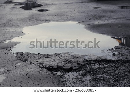 puddle on the road after the rain Royalty-Free Stock Photo #2366830857