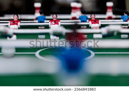 table soccer game with blue and red players are set up and redy for a play.