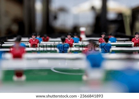 table soccer game with blue and red players are set up and redy for a play.