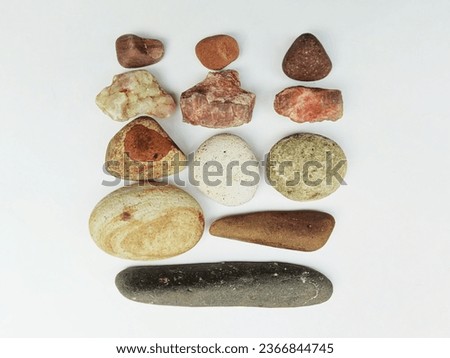 a collection of stones of various shapes, colors and sizes isolated on a white background