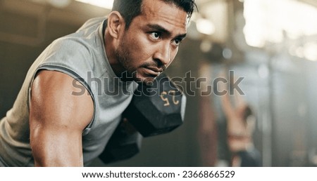 Serious man, dumbbell and weightlifting in workout, exercise or fitness at indoor gym. Active male person, bodybuilder or athlete lifting weight for intense arm training, strength or muscle at club Royalty-Free Stock Photo #2366866529