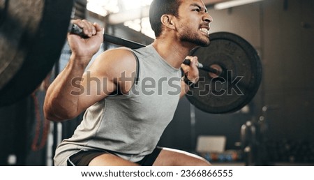Man at gym, weight lifting and barbell with focus on muscle building endurance, strong body and balance power in fitness. Commitment, motivation and bodybuilder in workout for health and wellness. Royalty-Free Stock Photo #2366866555