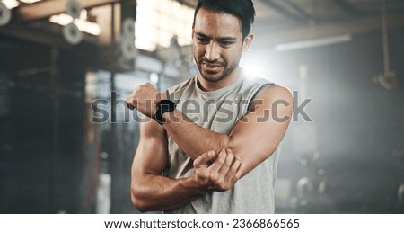 Arm pain, fitness and asian man at gym for training with joint problem, discomfort or arthritis. Elbow, injury and guy athlete with sports massage for osteoporosis, fibromyalgia or anatomy emergency Royalty-Free Stock Photo #2366866565