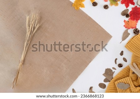 Modern office desk with yellow-red autumn leaves on white background with copy space. Place for your text. Work table with office supplies. concept cosy, cozy, seasonal autumn