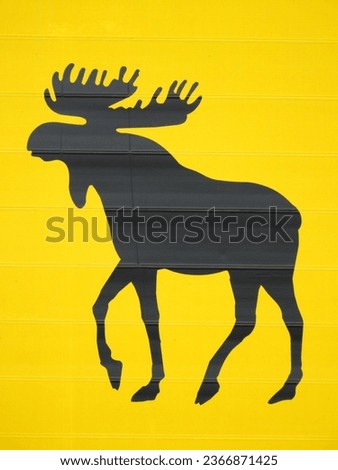 Yellow and black moose silhouette warning road sign highway