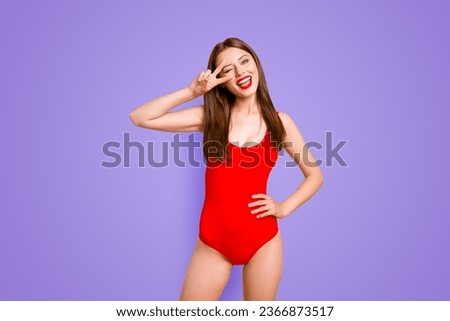 Party mood Portrait of foolish playful girl gesturing v-sign near winking eye showing tongue out looking at camera isolated on vivid yellow background