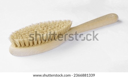 Natural bristle brush with wooden handle for dry massage isolated on white background. Royalty-Free Stock Photo #2366881339