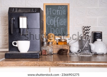 Home Coffee Station, hot drinks Bar. kitchen coffee corner with coffee machine, coffee beans, tea, sweets and toppings for drinks Royalty-Free Stock Photo #2366901275