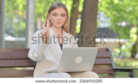 Young Businesswoman Shaking Head in Denial while Looking at Camera