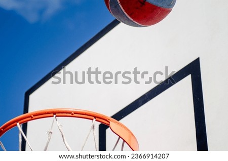 close-up view of a basketball basket and ball against a backboard