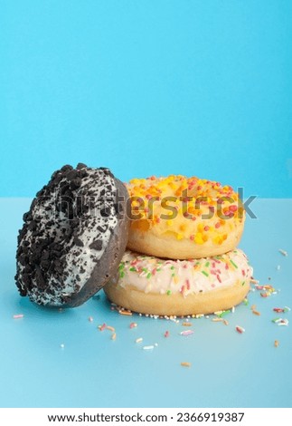 Doughnuts Isolated, Chocolate Brown, Yellow and Pink Donuts, Donuts Collection with Multicolored Sprinkles, Doughnuts on Blue Background