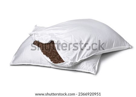 Pillowcase stuffed with buckwheat hulls isolated on white background close up Royalty-Free Stock Photo #2366920951