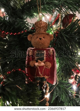 A close-up photo of a Bear Christmas toy tree decoration captures the festive spirit, with its intricate details and rich colors enhancing the holiday aesthetics and adding a touch of whimsy and joy.