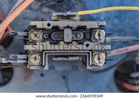 A contactor installed on an HVAC unit. This is a 24 volt contactor. When it is energized with 24 volts the contacts are pulled in allowing power to flow through, turning the system on.   Royalty-Free Stock Photo #2366939349