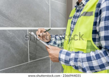 inspector or engineer is inspecting construction and quality assurance new house using a checklist. Engineers or architects or contactor work to build the house before handing it over to the homeowner Royalty-Free Stock Photo #2366944031