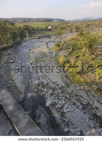 Beautiful view of a rocky river accompanied by trees and natural scenery in Bumiayu, Brebes Regency, Indonesia.  Picture taken from the Purwojaya train.