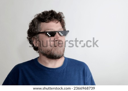 caucasian man with beard and pixelated glasses