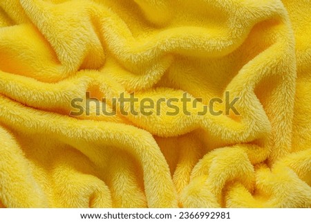 Macro yellow towel background,Terry cloth, yellow towel texture background. Soft fluffy textile bath or beach towel material 