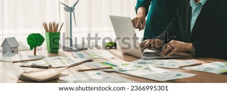 Eco business company meeting with group of business people using laptop to plan strategy and discuss marketing of eco-friendly and clean energy products. Green business company concept. Trailblazing Royalty-Free Stock Photo #2366995301