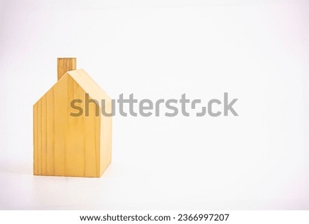 Small one-storey house model made of wood. Photograph.