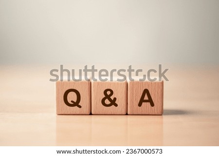 Question and Answer QA text on wooden block background. Business and communication concept.
