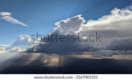 Down burst and draft from thunderstorm over Denver Colorado with sun beams peaking through