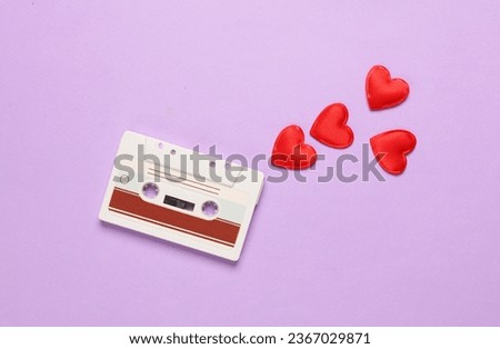 Audio cassette with hearts on purple background. Music lover, love song