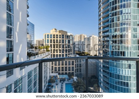 Contemporary Balcony Photoshoot footage located in Florida, USA. Showcasing modern architectural design and development. Beautiful clear sky and commercial area view.
