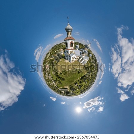 little planet transformation of spherical panorama 360 degrees overlooking church in center of globe in blue sky. Spherical abstract aerial view with curvature of space. Royalty-Free Stock Photo #2367034475