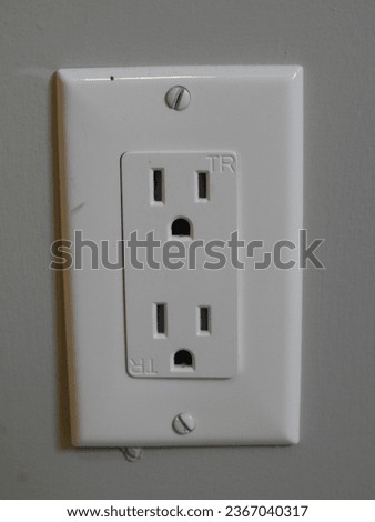 White electrical outlet socket on a wall closeup macro picture Royalty-Free Stock Photo #2367040317