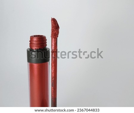 Lip cream, closeup with the bottle and the stick