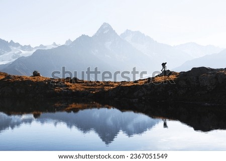 Tourist hiking near Lac de Cheserys lake in French Alps. Monte Bianco mountains range on background. Landscape photography. France, Chamonix, Graian Alps