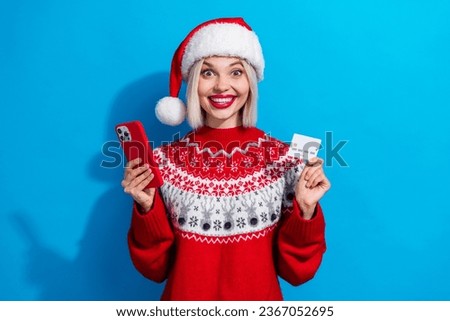 Photo of attractive positive person hold smart phone wireless debit card wear red x-mas eve jumper isolated on blue color background