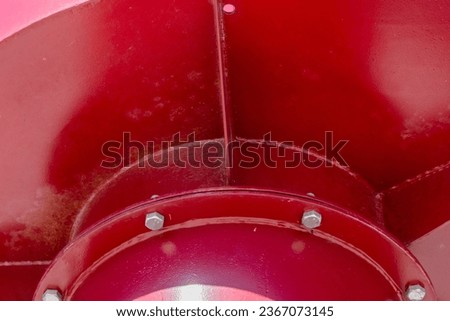 Robust, large, metal, burgundy construction with metal screw fastening in sunny day. Bright red metal parts bolted together. Copy space. Background for quotes. High quality photo