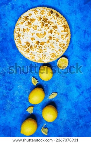 Traditional french lemon Meringue tart on blue grunge background