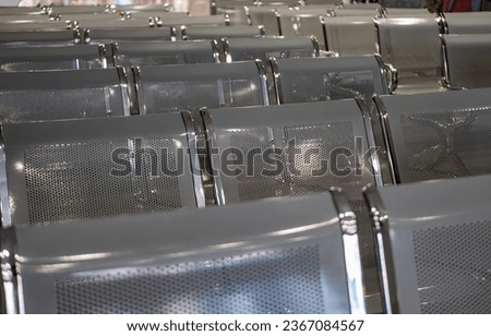 Waiting room. Gray metal benches. Aluminum chrome chairs in the auditorium. A row of seats at the airport.