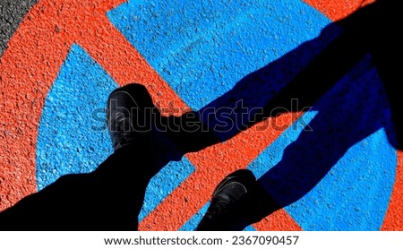 Silhouette of man over colorful forbidden signal on the ground