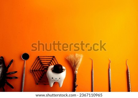 Happy halloween.dental concept.spider web pumpkin.dental tools on orange