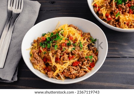 Spaghetti Squash Bolognese Garnished with Parsley: Bowls of spaghetti squash served with a ground beef and tomato sauce Royalty-Free Stock Photo #2367119743